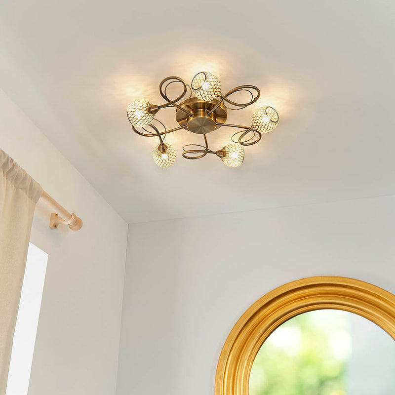 Aherne 5 Light Flush Ceiling Light lit up in a styled living room