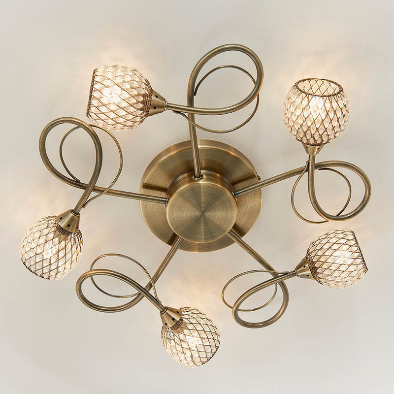 Aherne 5 Light Flush Ceiling Light in antique brass shown in a room setting