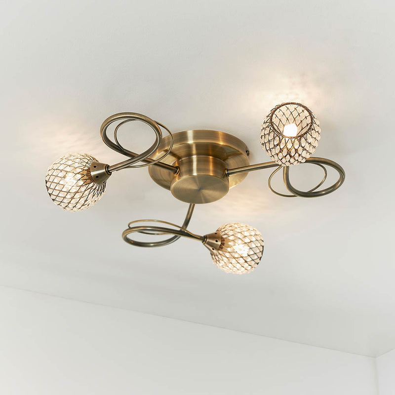Aherne 3 Light Flush Ceiling Light in antique brass on a bedroom ceiling