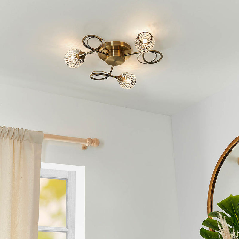 Aherne 3 Light Flush Ceiling Light lit up in a styled bedroom