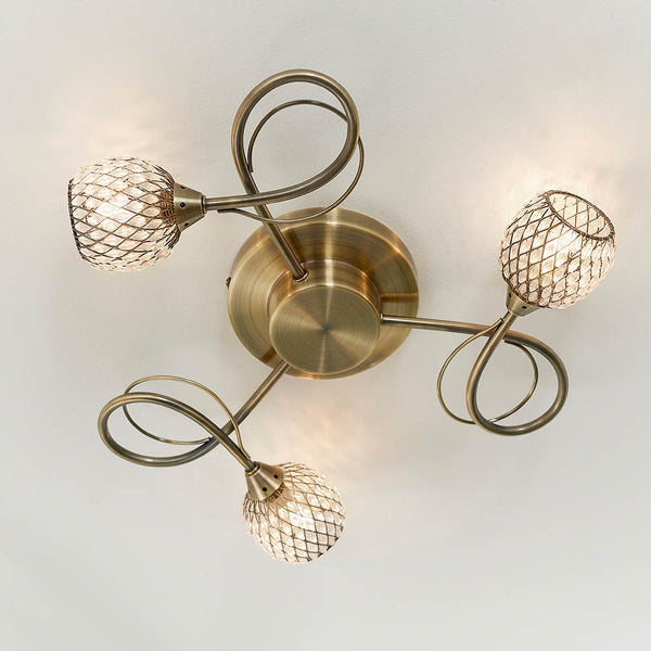 Aherne 3 Light Flush Ceiling Light in antique brass shown in a room setting