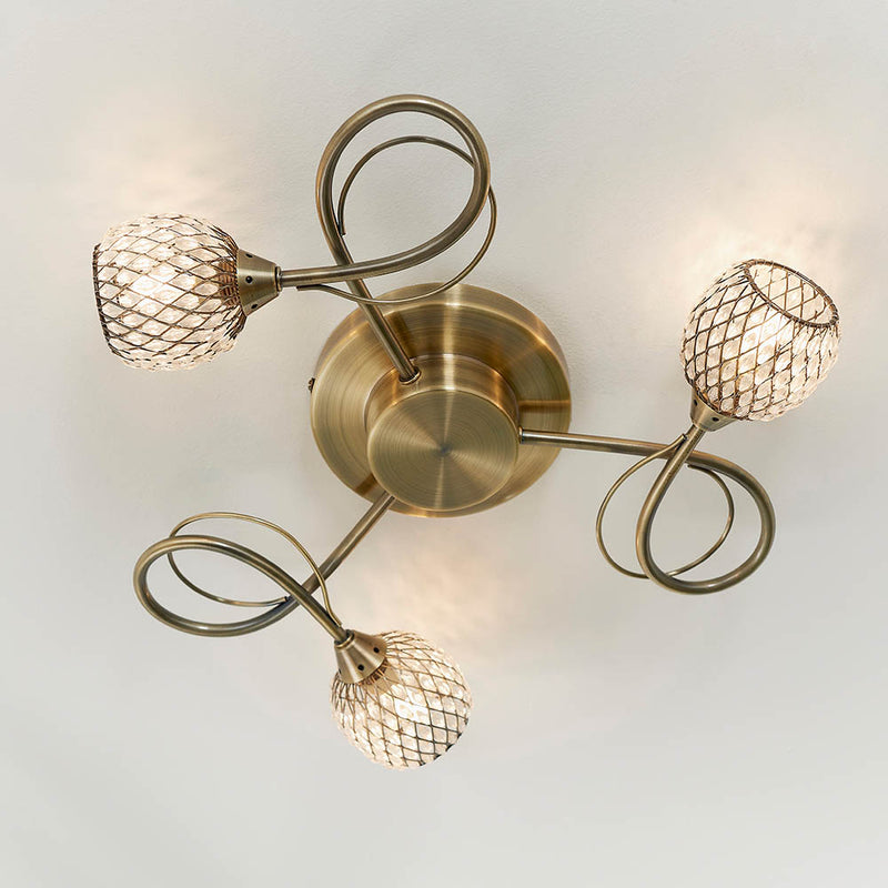 Aherne 3 Light Flush Ceiling Light in antique brass shown in a room setting