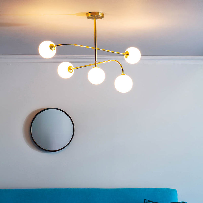 Otto 5 Light Semi Flush Ceiling Light in satin brass on a living room ceiling