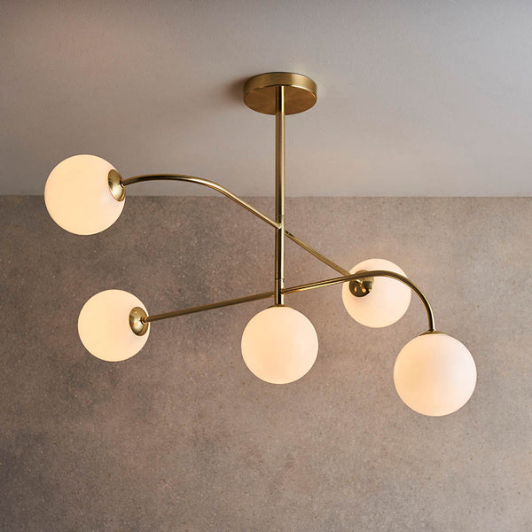 Otto 5 Light Semi Flush Ceiling Light lit up in a styled living room