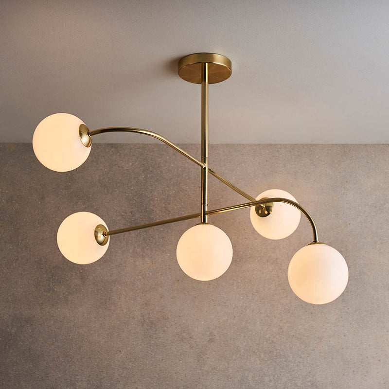 Otto 5 Light Semi Flush Ceiling Light lit up in a styled living room