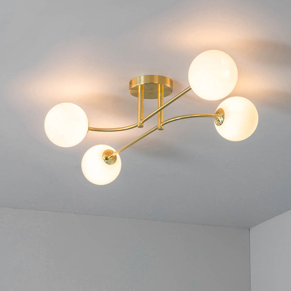 Otto 4 Light Semi Flush Ceiling Light in satin brass on a living room ceiling