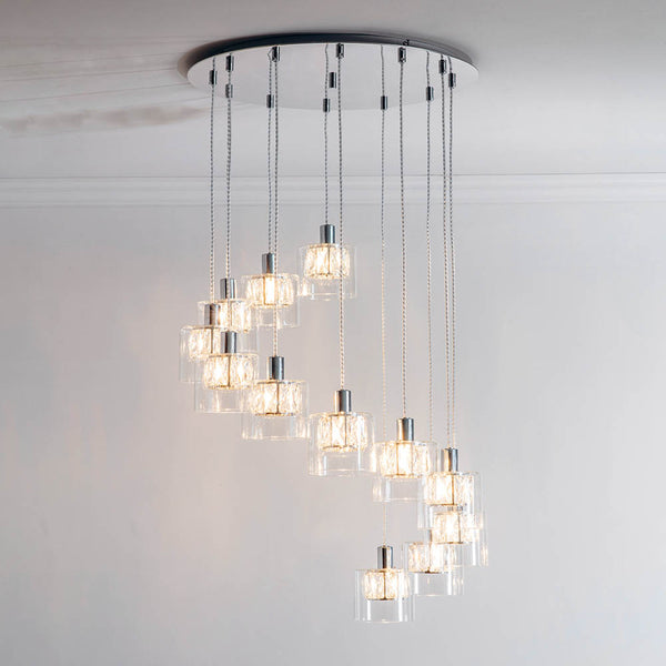 Verina 12 Light Cascade Pendant lit up in a styled stairwell