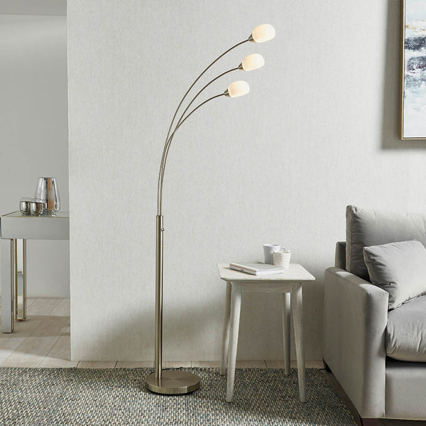 Jaspa 3 Light LED Arc Floor Lamp lit up in a living room setting