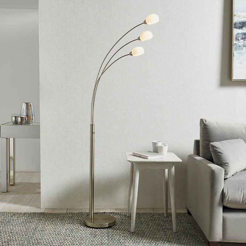 Jaspa 3 Light LED Arc Floor Lamp lit up in a living room setting