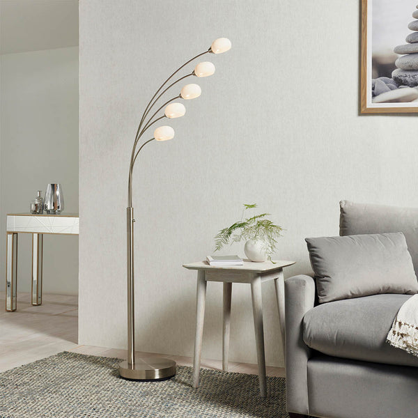 Jaspa 5 Light LED Arc Floor Lamp lit up in a living room setting