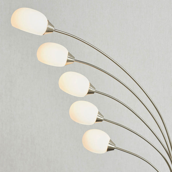 Jaspa 5 Light LED Arc Floor Lamp lit up in a living room setting