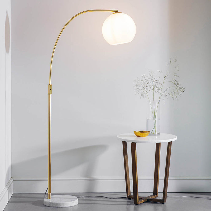 Otto Floor Lamp lit up in a living room setting
