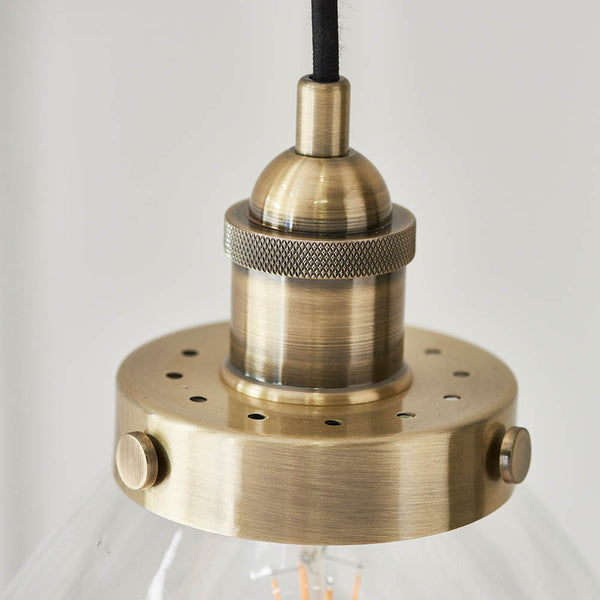 Hansen Pendant in antique brass shown in a room setting
