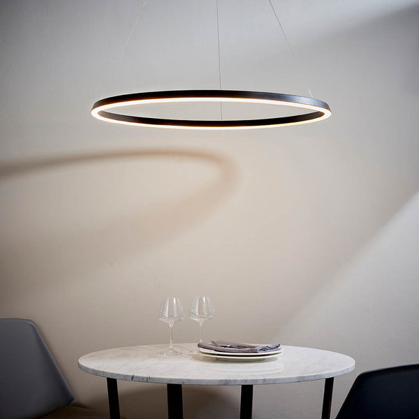 Staten LED Hoop Pendant lit up in a styled living room