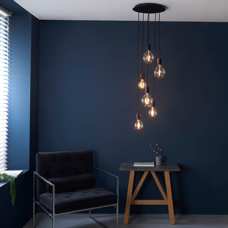 Studio 6 Light Cluster Pendant in matt black hanging in a dining room