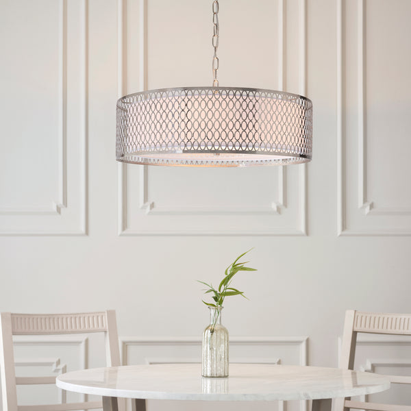 Cordero 3 Light Pendant lit up in a styled living room