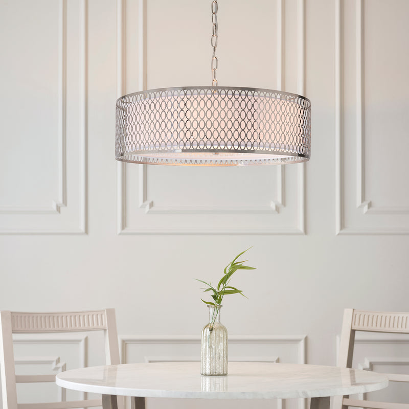 Cordero 3 Light Pendant lit up in a styled living room