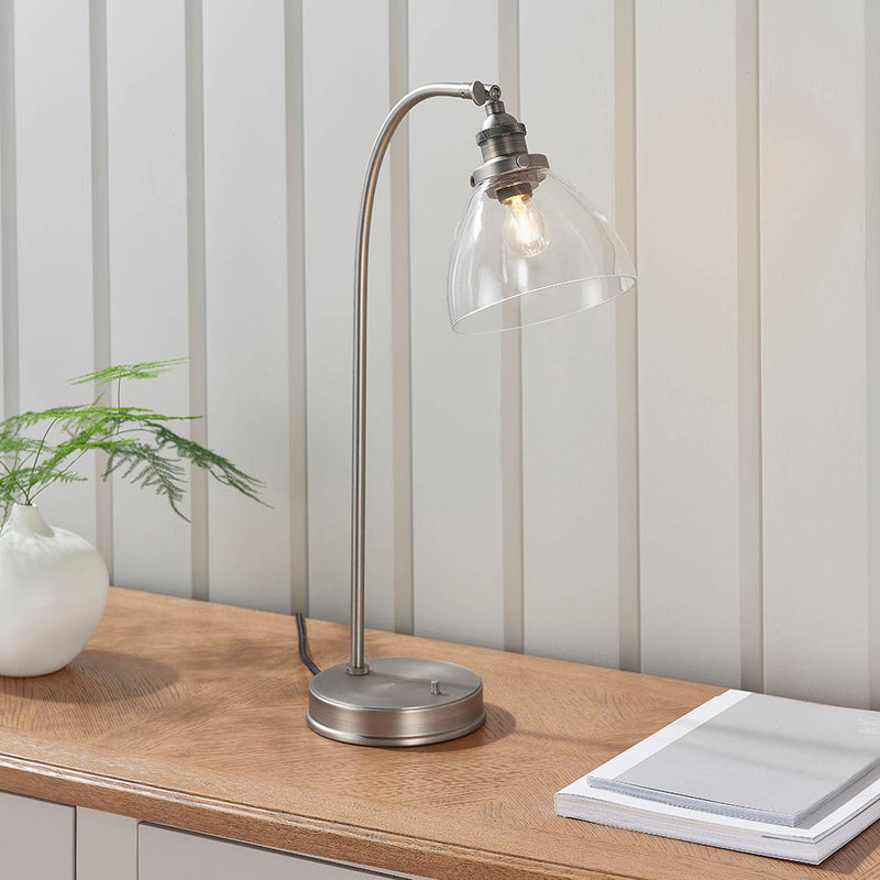Hansen Task Table Lamp lit up in a bedroom setting