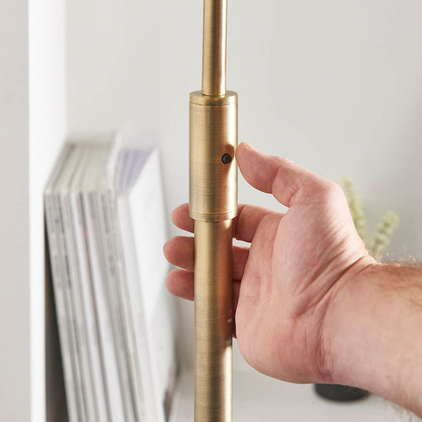 Detail of the antique brass and black marble finish on the Otto Floor Lamp