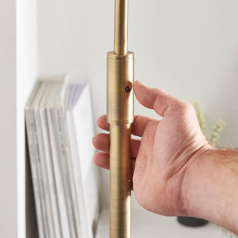 Detail of the antique brass and black marble finish on the Otto Floor Lamp