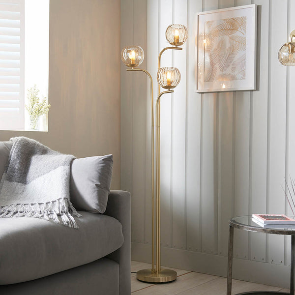 Endon Dimple 3 Light Floor Lamp in satin brass in a styled living room