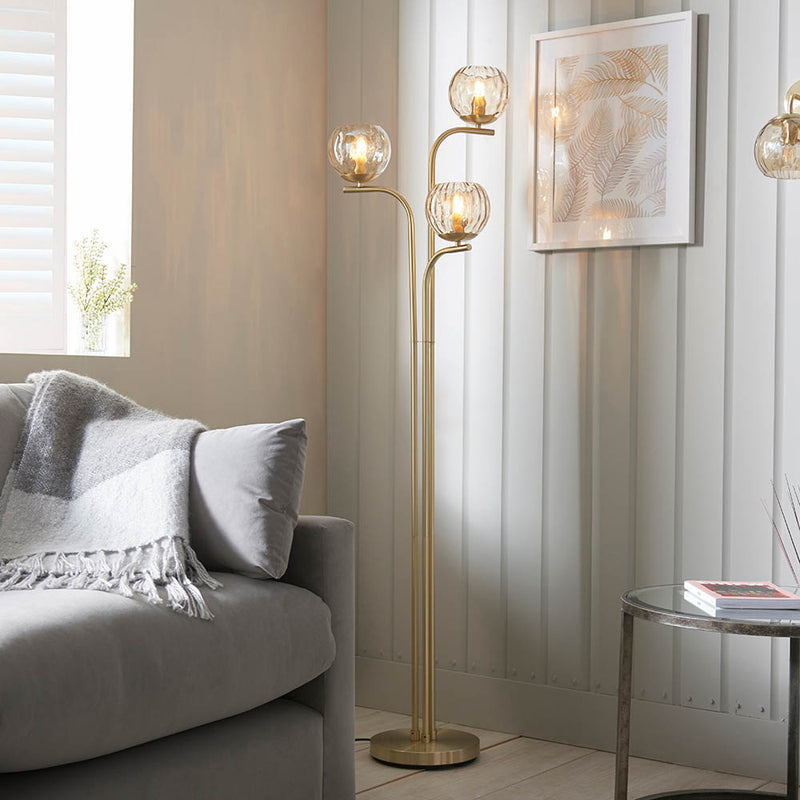 Endon Dimple 3 Light Floor Lamp in satin brass in a styled living room