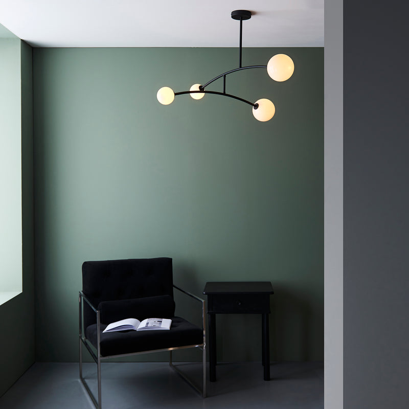 Balance 4 Light Semi Flush Ceiling Light lit up in a styled living room