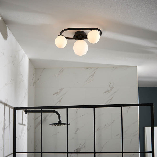 Pulsa 3 Light Bathroom Ceiling Light in matt black and white glass on a bathroom ceiling