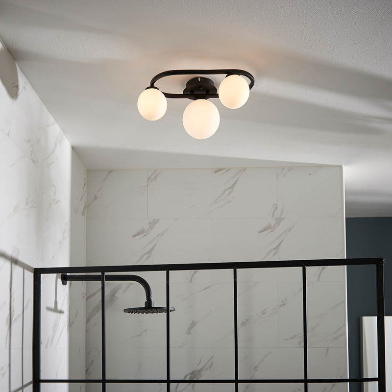 Pulsa 3 Light Bathroom Ceiling Light in matt black and white glass on a bathroom ceiling