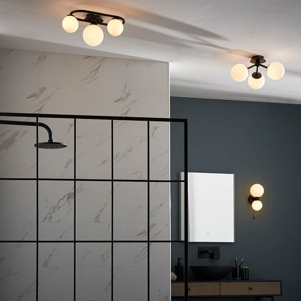 Pulsa 3 Light Bathroom Ceiling Light lit up in a styled bathroom