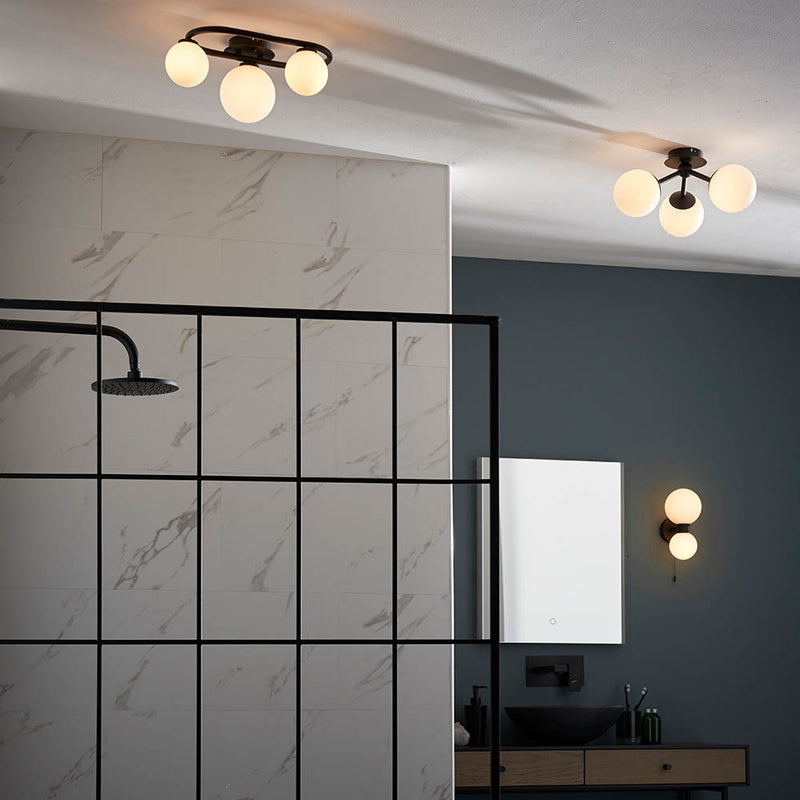 Pulsa 3 Light Bathroom Ceiling Light lit up in a styled bathroom