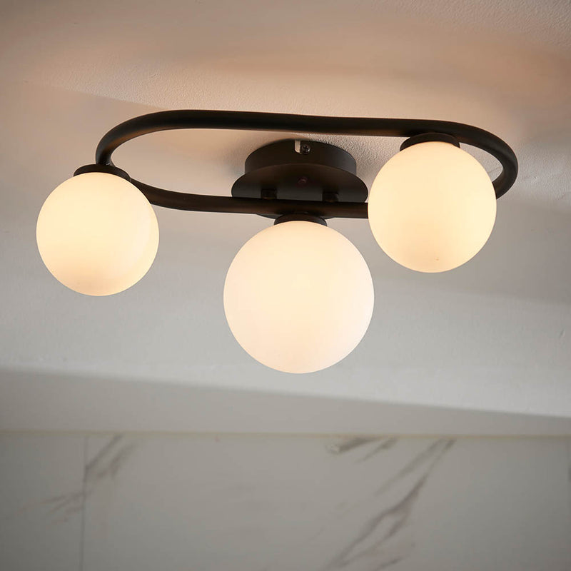 Pulsa 3 Light Bathroom Ceiling Light in matt black and white glass shown in a room setting