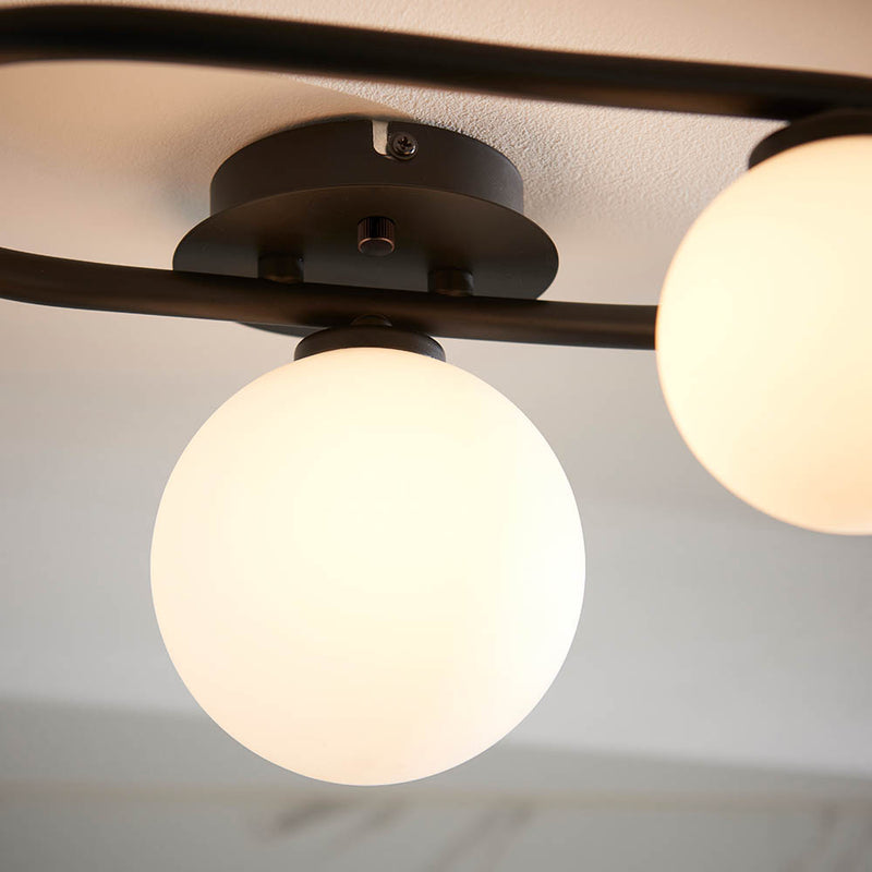 Detail of the matt black and white glass finish on the Pulsa 3 Light Bathroom Ceiling Light