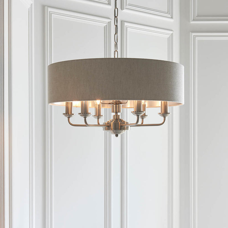 Highclere 6 Light Drum Pendant in brushed chrome hanging in a living room