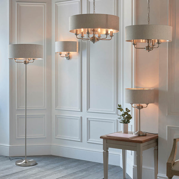 Highclere 3 Light Floor Lamp lit up in a living room setting