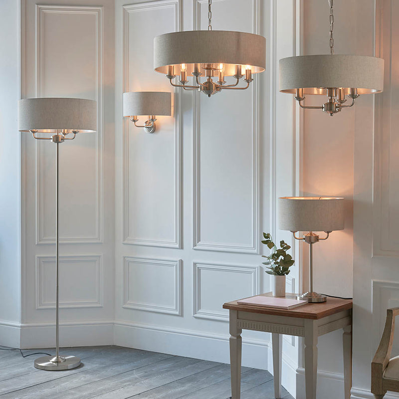 Highclere 3 Light Floor Lamp lit up in a living room setting