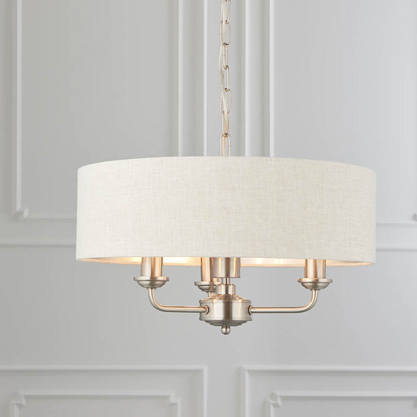 Highclere 3 Light Drum Pendant in brushed chrome hanging in a bedroom