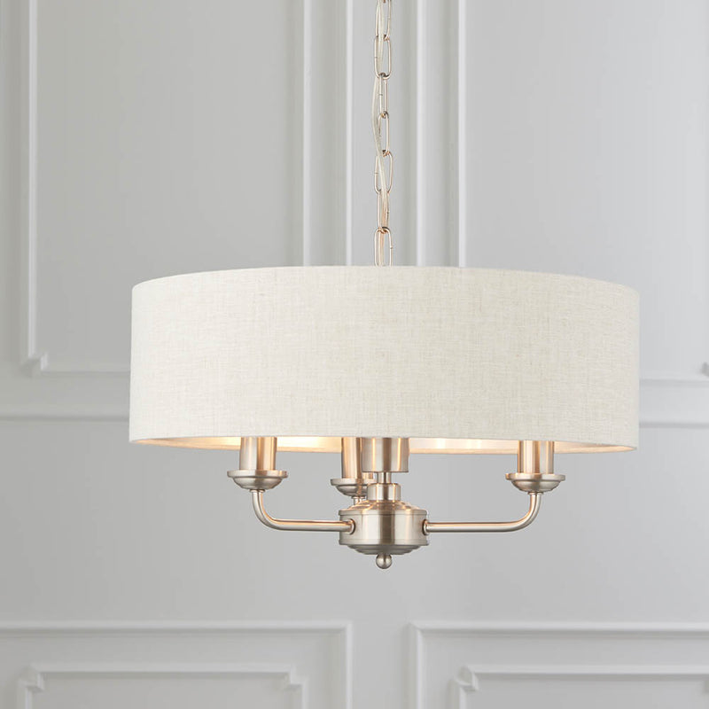 Highclere 3 Light Drum Pendant in brushed chrome hanging in a bedroom