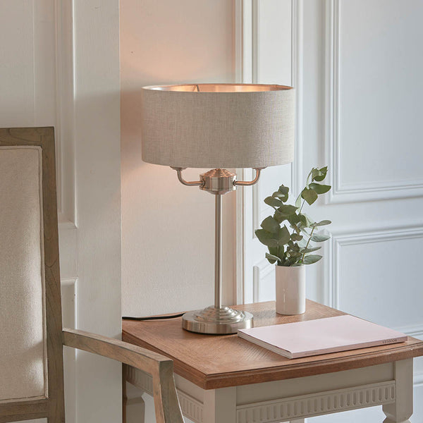 Endon Highclere 3 Light Table Lamp in brushed chrome and linen in a styled living room