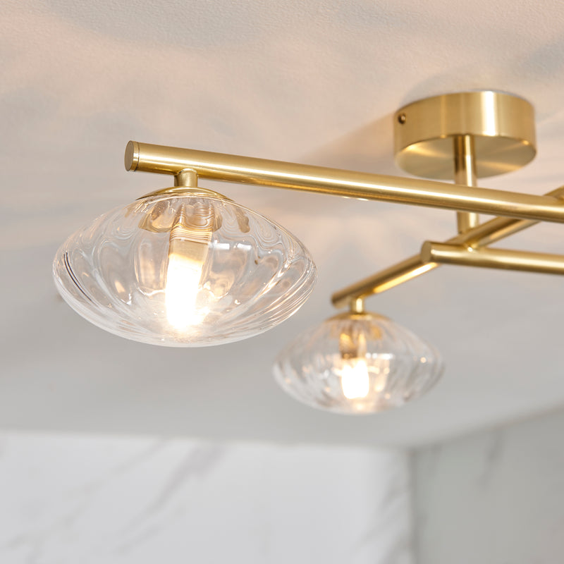 Mobias 4 Light Bathroom Ceiling Light in satin brass shown in a room setting