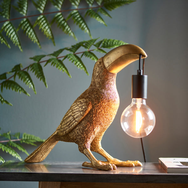 Endon Toucan Table Lamp in vintage gold in a styled living room