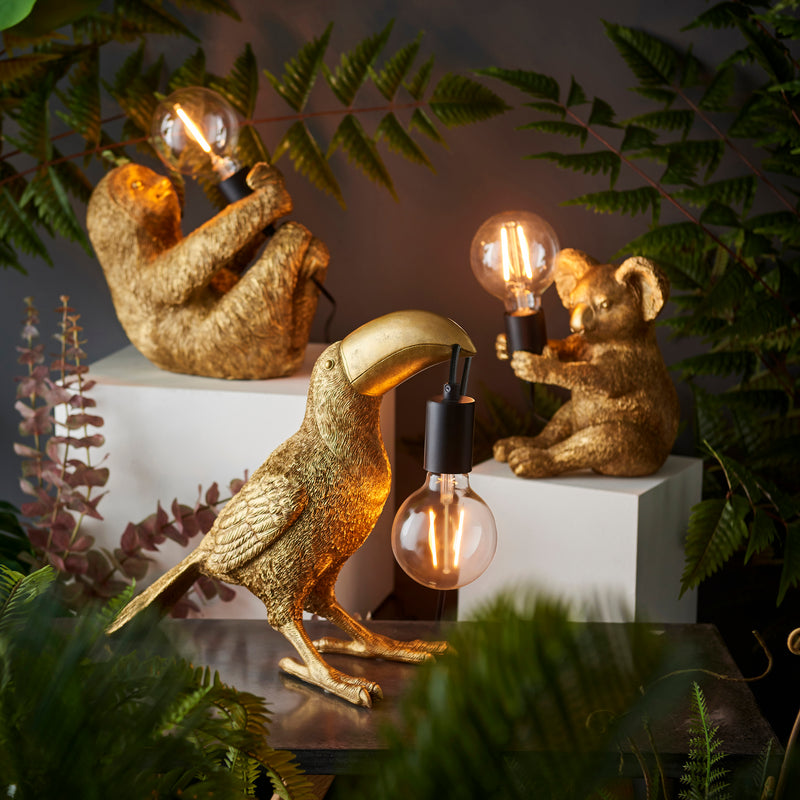 Toucan Table Lamp lit up in a living room setting