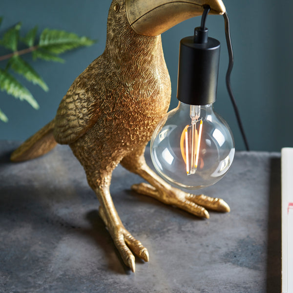 Detail of the vintage gold finish on the Toucan Table Lamp