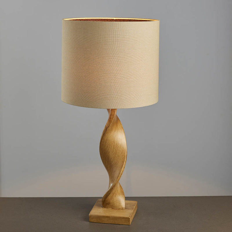 Abia Table Lamp lit up in a bedroom setting