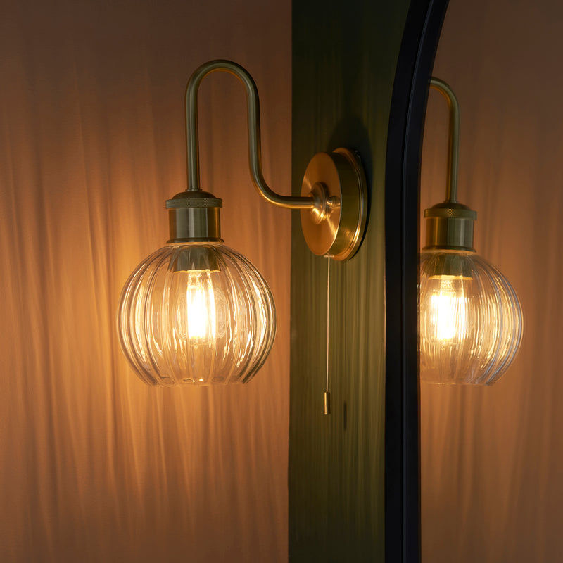 Kendall Bathroom Wall Light lit up in a styled bathroom