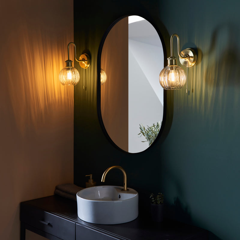 Kendall Bathroom Wall Light in satin brass shown in a room setting