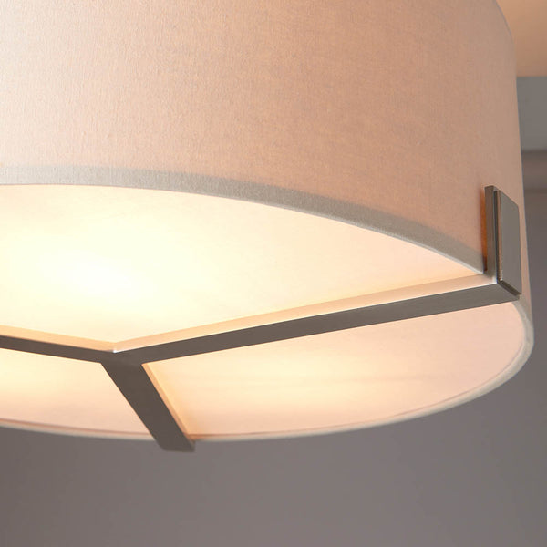 Hayfield 3 Light Drum Pendant lit up in a styled living room