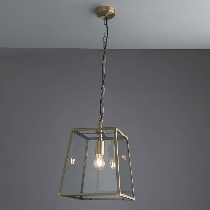 Hurst Lantern Pendant in matt antique brass hanging in a hallway