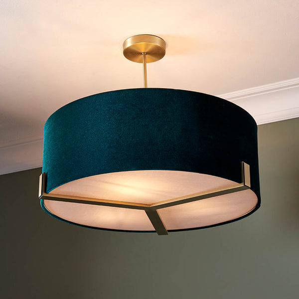 Hayfield 3 Light Drum Pendant in antique brass and green velvet hanging in a living room