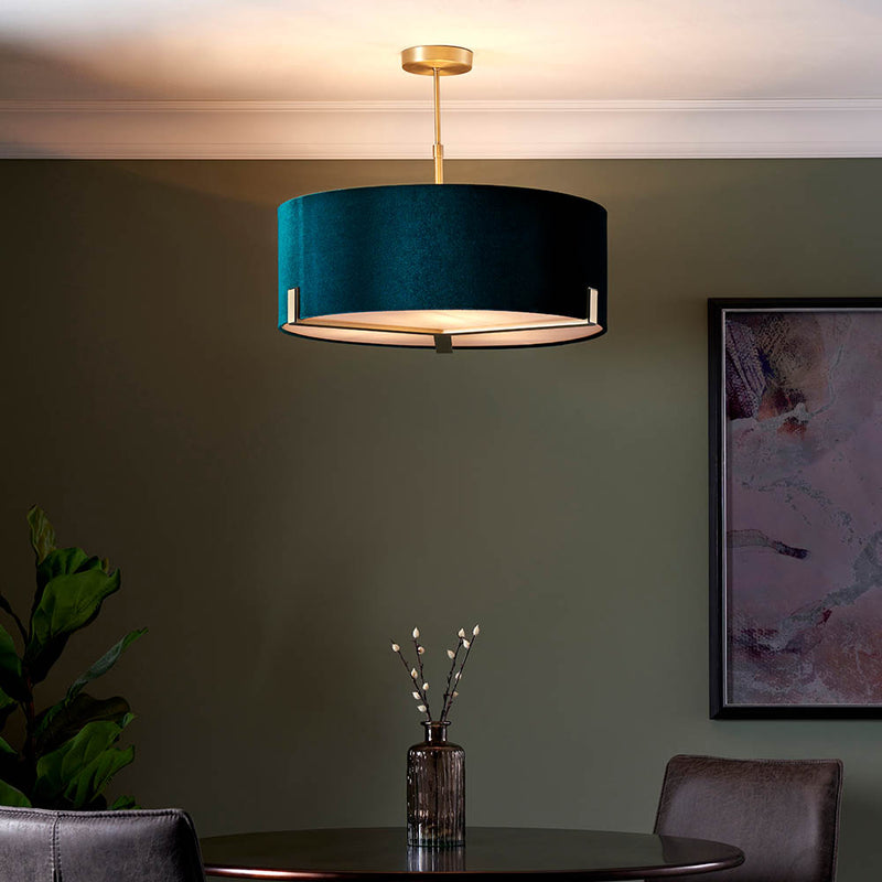 Hayfield 3 Light Drum Pendant lit up in a styled living room
